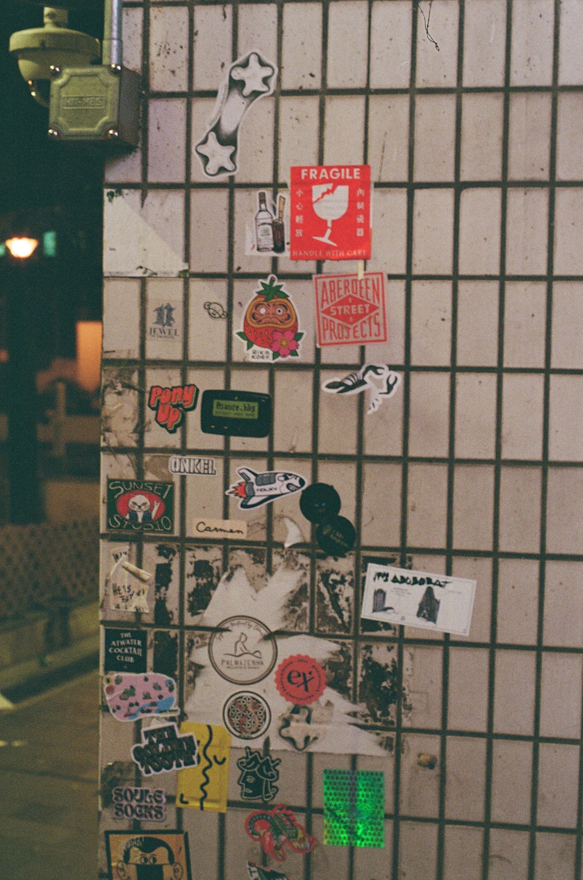 Sticker-covered wall on a Hong Kong street
